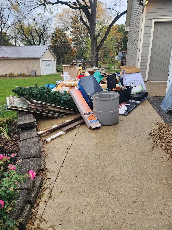 Dumpster being loaded with debris for Commercial Dumpster Rental in Tecumseh